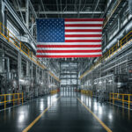 American flag hanging prominently inside a spacious industrial factory hall with machinery and equipment, symbolizing U.S. manufacturing and business investment.